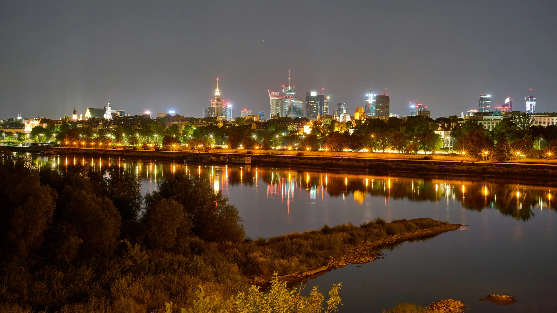 Warsaw skyline at night above the Vistula River
